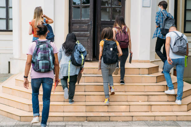 istock Group of students walking in college 1279770392