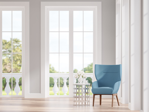 Modern classic living room with blue lounge chair 3d render.The Rooms have wooden floors and gray wall.Focus on the chair with a blurry nature background.