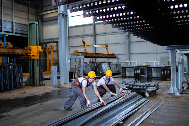 istock Factory workers working with metal parts in industrial hall. 1279773250