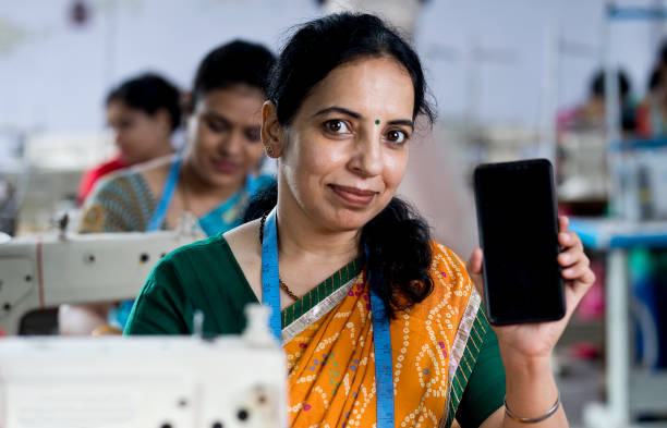 istock Indian woman textile worker showing mobile phone 1279774214