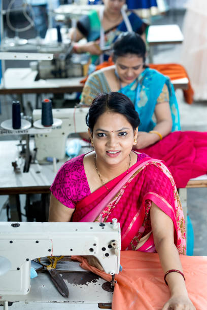 istock Indian women textile workers on production line 1279774378