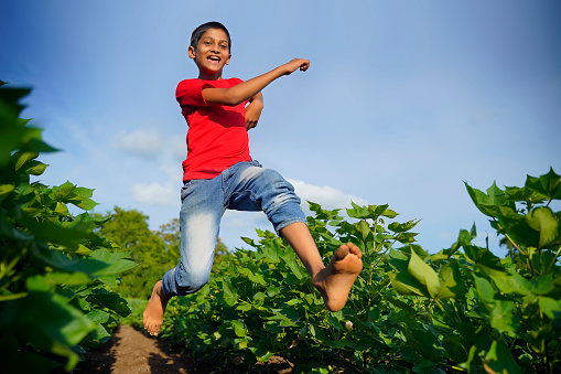 Happy indian child jumping in air