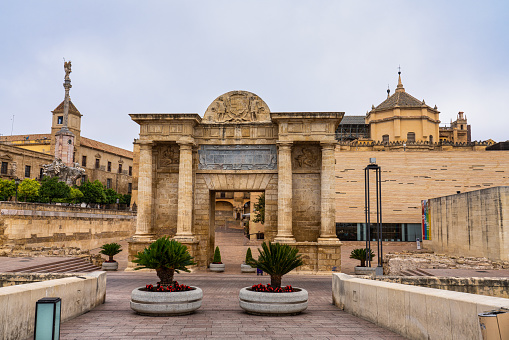 Cordoba, Spain - October 31, 2019: Puerta del Puente Gate, Arch of triumph and cathedral mosque in Cordoba, Andalusia, Spain