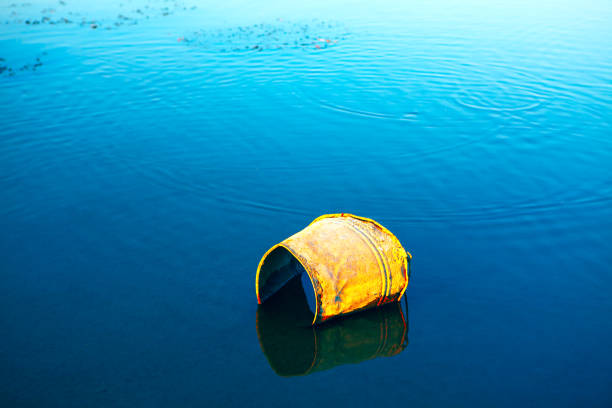 A red buoy frozen in ice in a winter water surface.