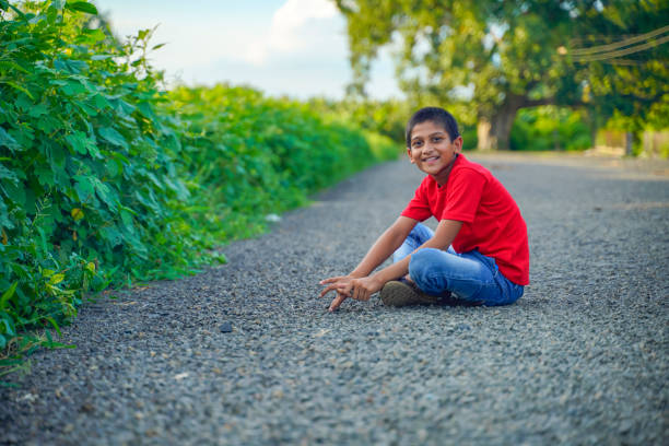 istock indian child playing with stone 1279775518