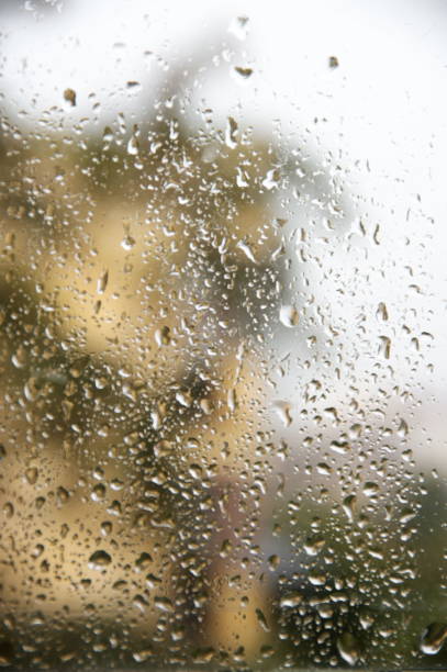 istock View through window with water drops at rainy weather 1279775792