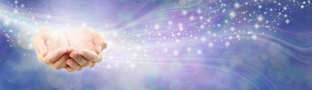 High Resonance Healing Energy Message Background female cupped hands beside a flow of sparkles against a lilac blue  energy field background with copy space reiki photos stock pictures, royalty-free photos & images