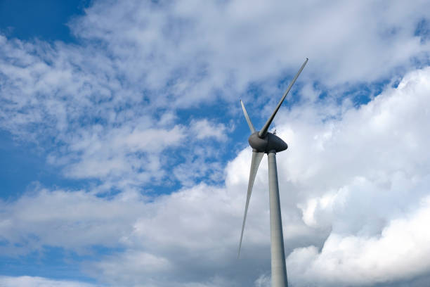 istock Wind turbine in a wind farm during a windy day with clouds in the background 1279776910