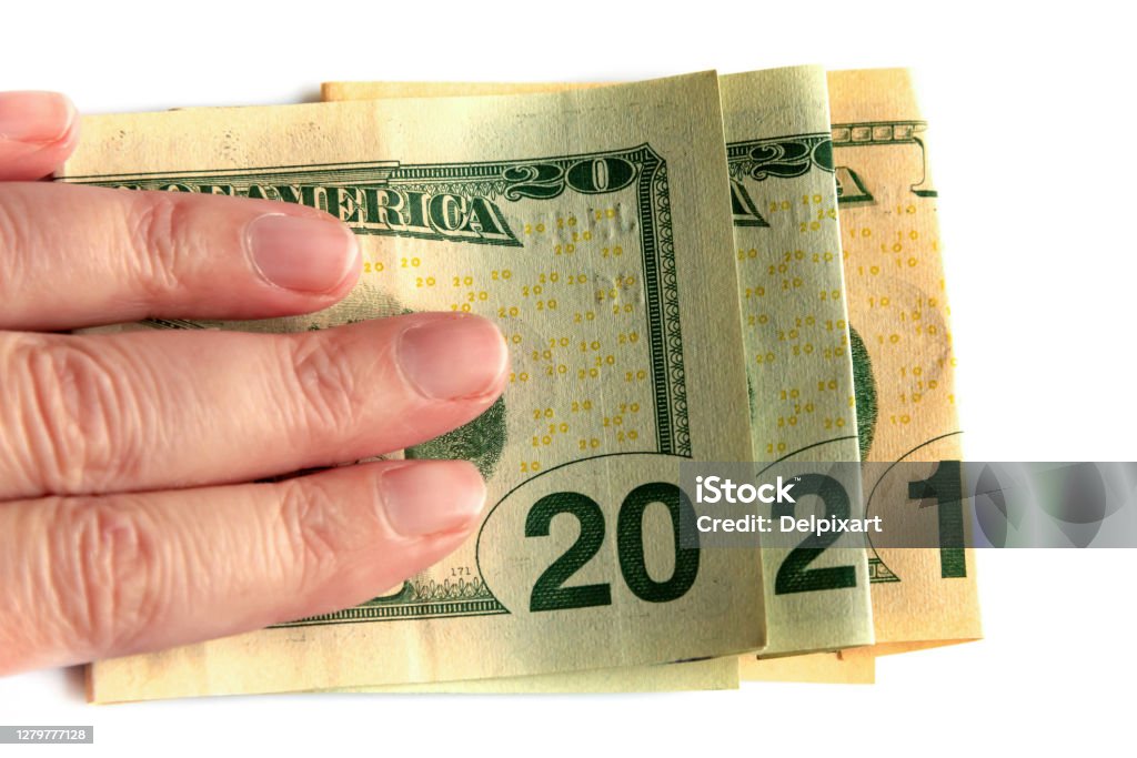 2021 written with dollars bank notes in a hand isolated on white background, new year greetings money concept 2021 Stock Photo
