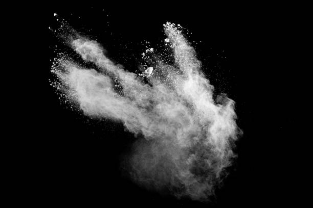 istock White powder explosion clouds.Freeze motion of white dust particles splash on black background. 1279777828