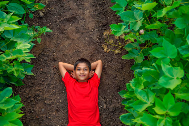 istock Smiling cute indian boy laying on ground 1279778021