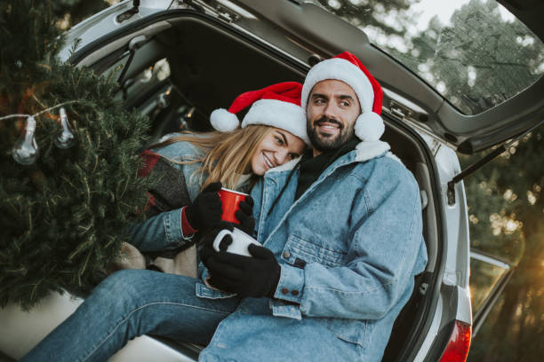 istock Couple having fun on Christmas tree adventure. 1279778289