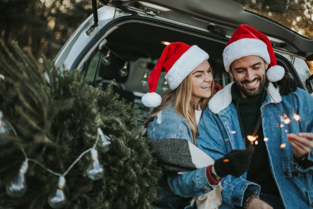 istock Couple having fun on Christmas tree adventure. 1279779341