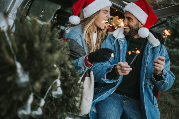 istock Couple having fun on Christmas tree adventure. 1279779427