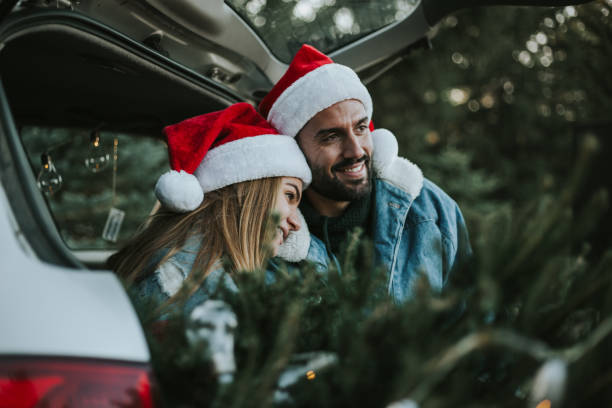 istock Couple having fun on Christmas tree adventure. 1279779454