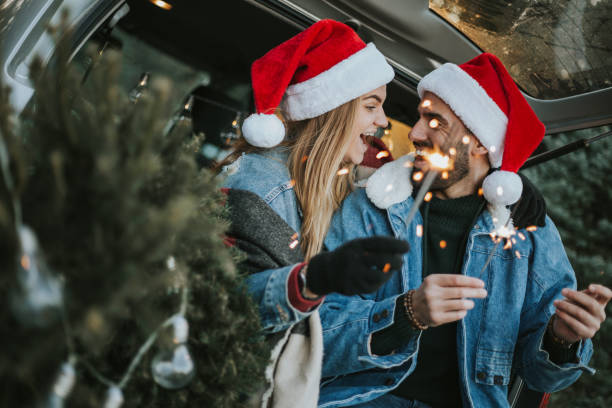 istock Couple having fun on Christmas tree adventure. 1279779976