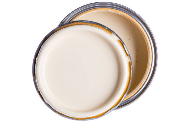 istock Paint can with ivory color top view isolated on white 1279780291