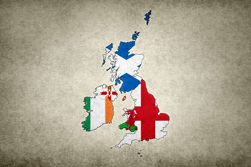 Grunge map of the British Isles with its flags printed within its borders on an old paper.