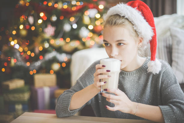 istock young woman in christmas interior with latte 1279780499