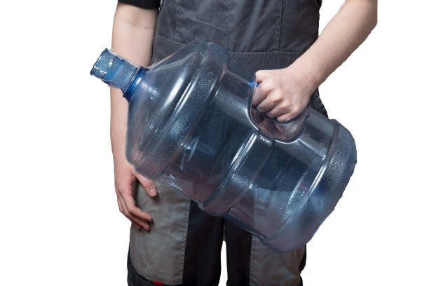 istock Bottled water delivery man on a white background. 1279781379