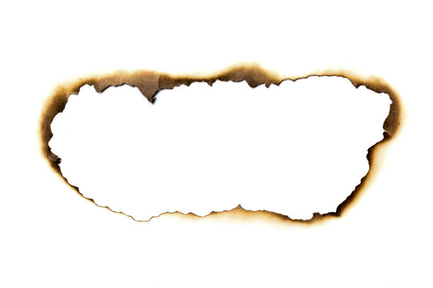 Fire burned hole white paper background texture isolated on white background. Paper burn mark stain Fire burned hole white paper background texture isolated on white background. Paper burn mark stain. at the edge of burnt frame grunge stock pictures, royalty-free photos & images