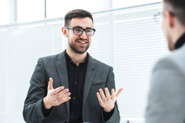 istock attractive young employee explaining his ideas to a colleague 1279783080