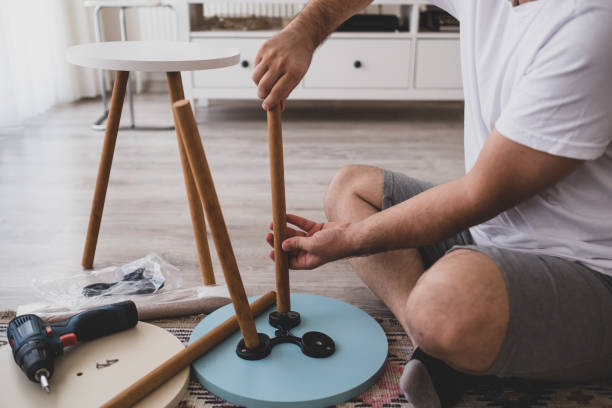istock Man assembling by turning the coffee table leg with his hand 1279783194