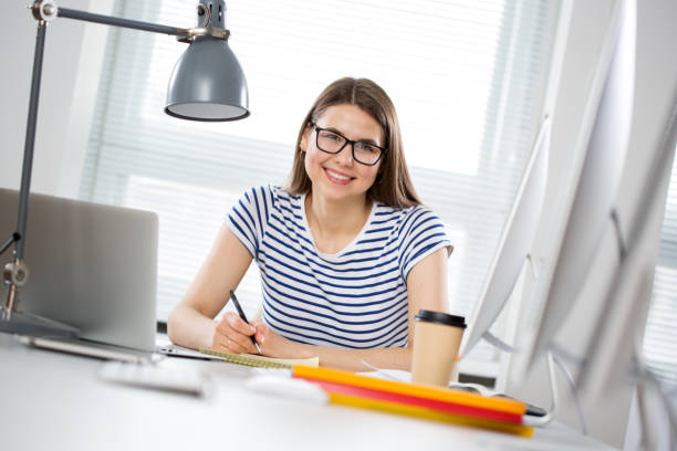 istock Portrait of a happy female student in a computer class 1279783207