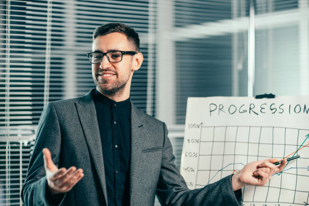 istock smiling businessman pointing to a flipchart with a financial chart 1279783275