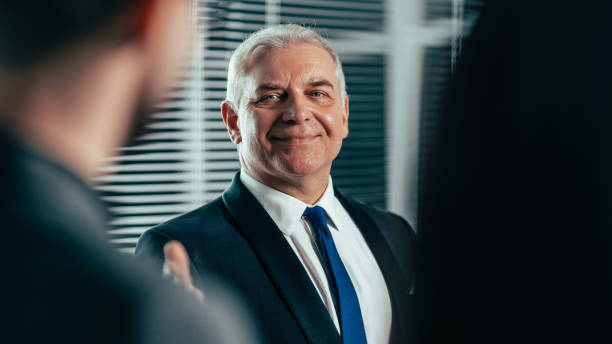 istock successful businessman pointing to a flipchart with financial indicators 1279783282