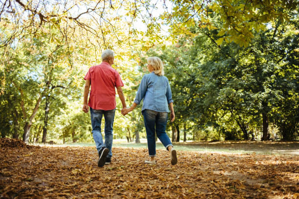 istock Happy senior couple going for a walk in the park 1279785746