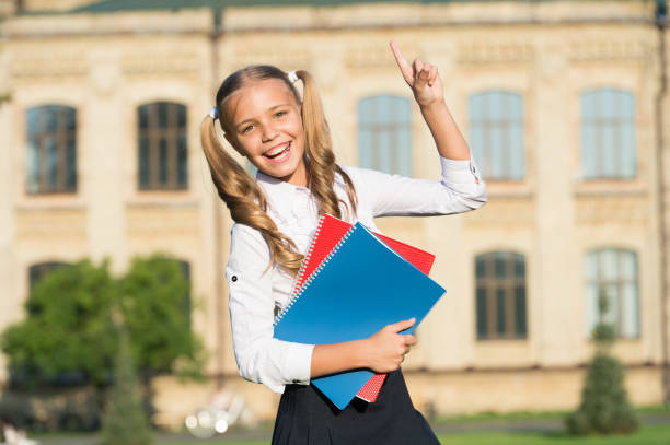 Done with homework. Happy kid got homework idea outdoors. Homework club. Afterschool activities. Homework assignment. Reading list. Home schooling. School and education.