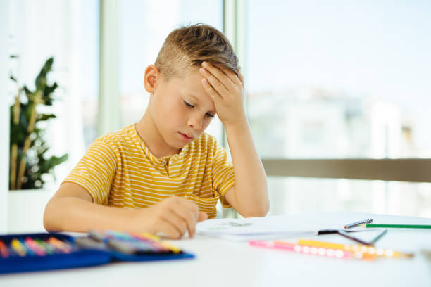 istock Young boy doing his homework. Back to school. Online class from home. 1279786562