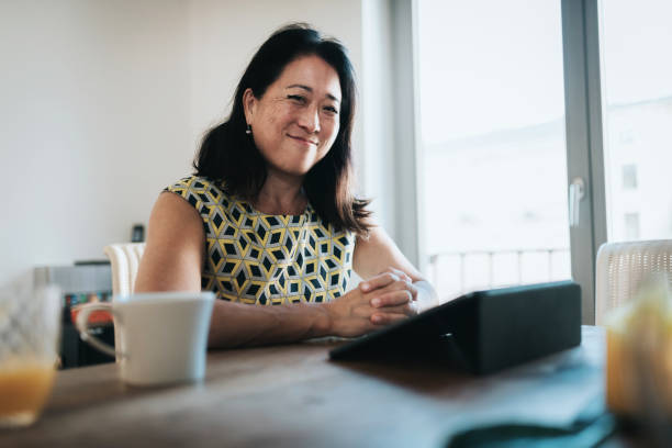 istock smiling elegant woman having video call on digital tablet 1279787442