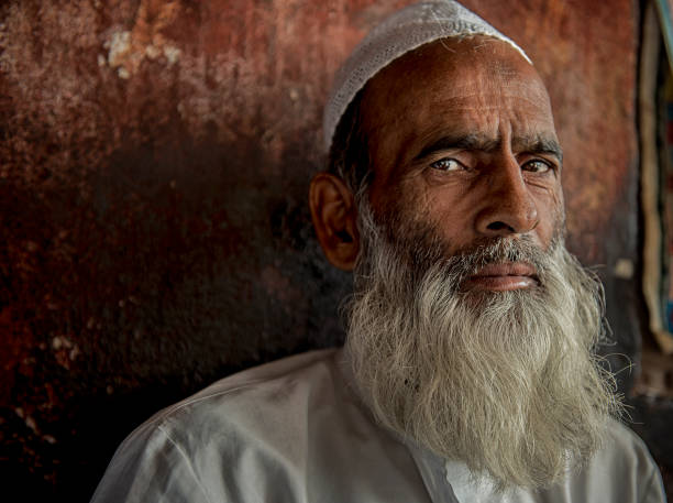 Unidentified faces of Indian Muslim poses for camera in the street of Old Delhi, India. stock photo