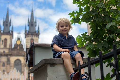 Cute child, boy, visiting Prague after the quarantine Covid 19, empty streets