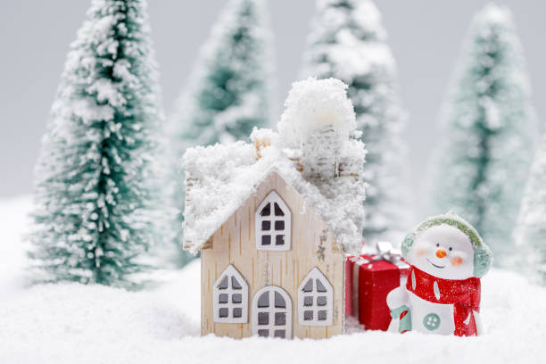 istock Snowman and house in winter 1279790550