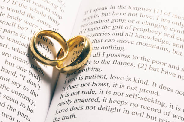 istock Golden wedding rings on bible book 1279790555