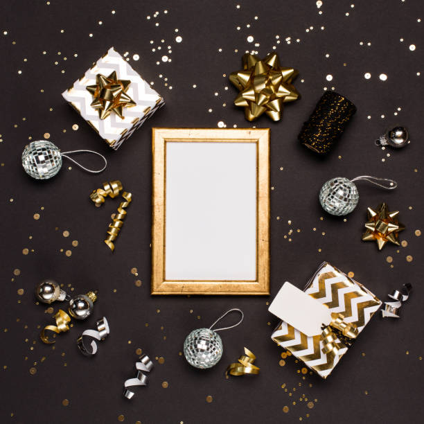 istock Christmas composition. Gold and silver decorations, mirror disco balls, gifts on  dark black background. 1279791991