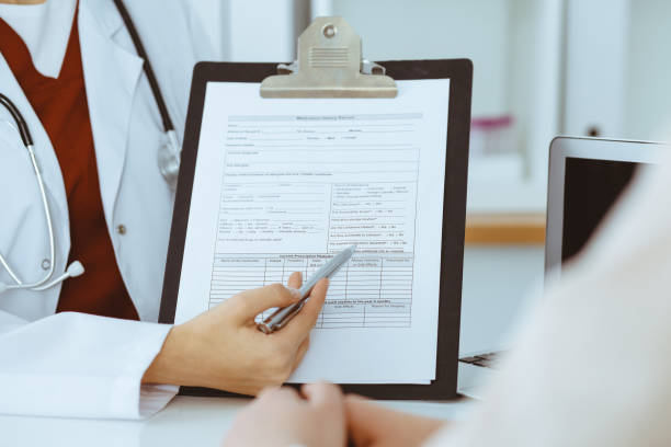 istock Unknown woman-doctor consulting patient and using clipboard with a medication history record. Medicine concept 1279792041