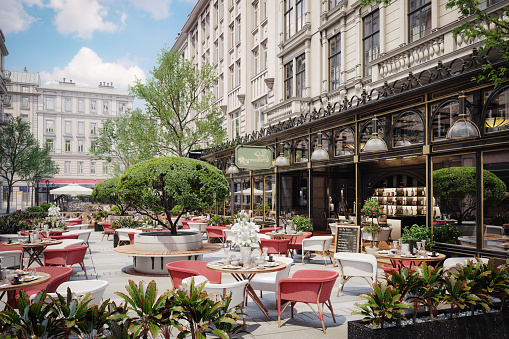 Empty cafe with terrace with tables and wooden chairs. Street vintage exterior of restaurant. Furniture for coffee shop in street in Europe. Typical view of Parisian street with tables of cafe