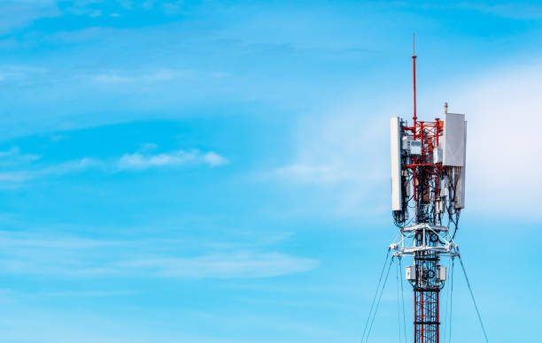 istock Telecommunication tower with blue sky and white clouds background. Antenna on blue sky. Radio and satellite pole. Communication technology. Telecommunication industry. Mobile or telecom 4g network. 1279792519