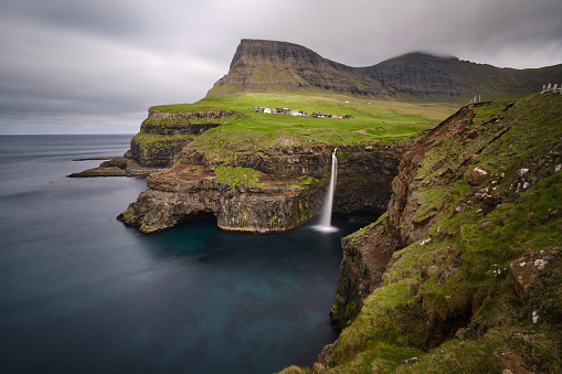 long exposure from Múlafossur Waterfall in the Faroe Islands in a typical cloudy day
