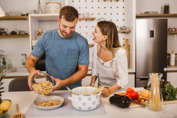 istock Young couple cooking together in kitchen 1279794619