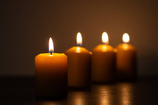istock Row of lit candles burning in the dark 1279795993