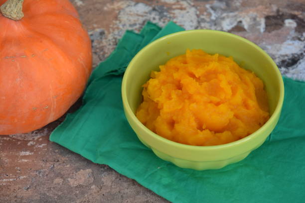 istock Pumpkin puree in a bowl with fresh pumpkin 1279796171