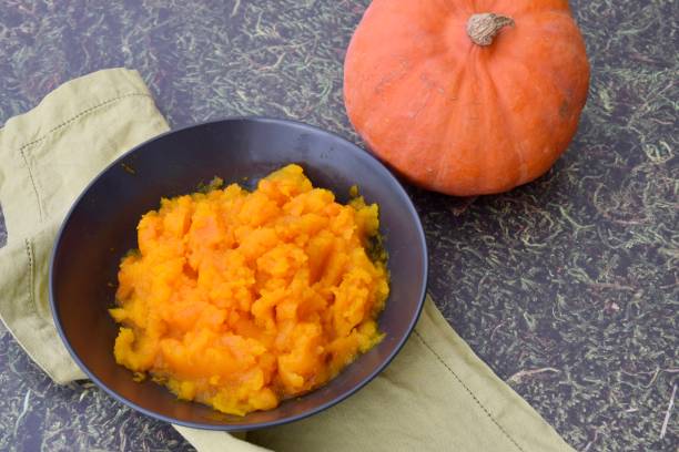 istock Pumpkin puree in a bowl with fresh pumpkin 1279796188