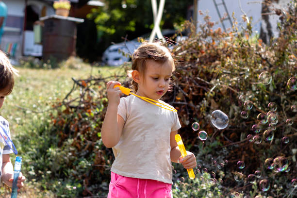 istock Girl catching soap bubbles. 1279797299