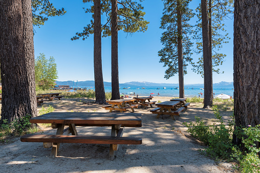 Tables and benches in picnic area in Tahoe Lake in Sierra Nevada, California, USA