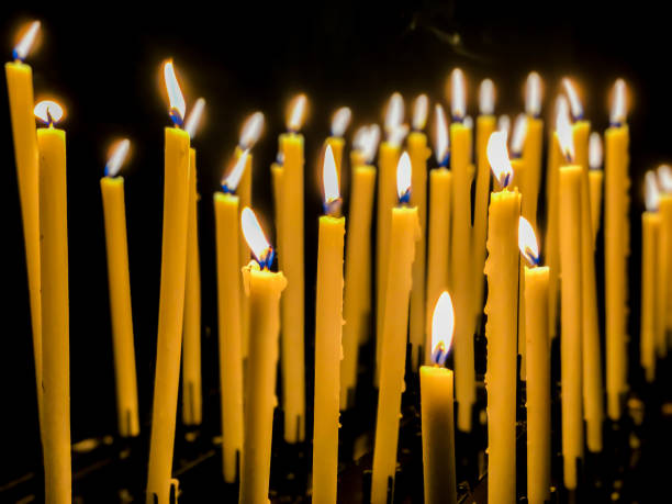 istock candle lights burning for wish in a church 1279798944